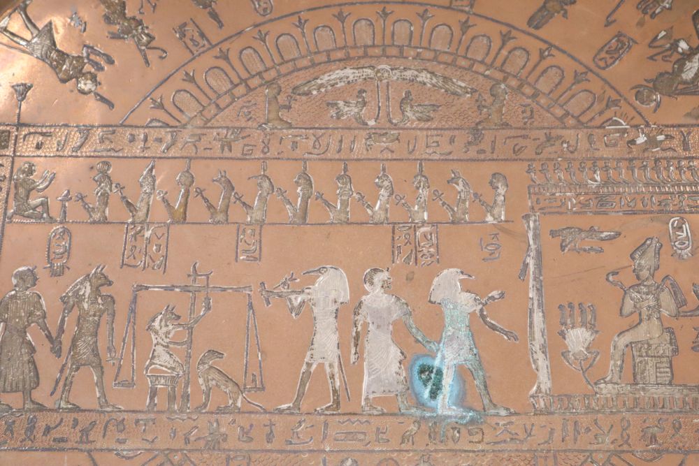 A large circular copper tray with white metal inlay depicting ancient Egyptian scenes, diameter 61cm